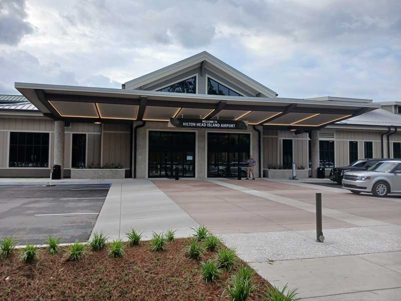 Hilton Head Island Airport entrance with covered canopy, landscaped grounds, and passenger drop-off area.